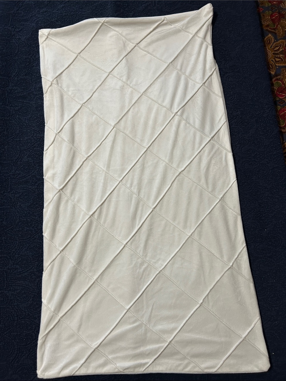 Pair of cream colored king pillow shams with lattice stitched pattern.